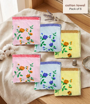 Pack of six cotton towels with floral designs on a wooden surface.