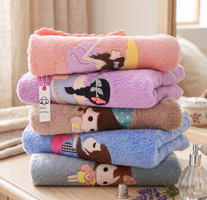 Stack of colorful plush blankets with cartoon characters on a wooden surface.